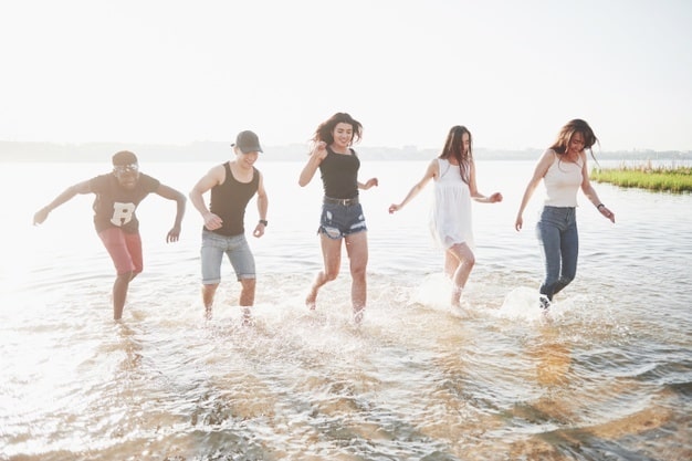Happy-Friends-Have-Fun-Beach-Young-People-Playing-Open-Air-Water-Summer-Holidays
